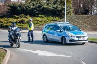 Fotografia kolorowa. Przedstawia uczestników przejazdu motocyklowego oraz policjantów zabezpieczających to wydarzenie.