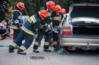 Zdjęcie kolorowe, przedstawiające festyn bezpieczeństwa i prace przy rozcinaniu pojazdów.