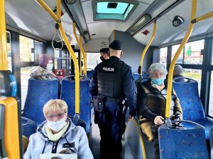 Zdjęcie kolorowe, przedstawiające policjantów w autobusie.