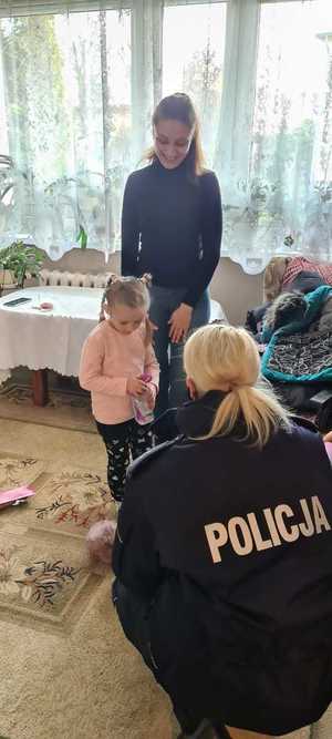 Zdjęcie przedstawiające rodzinę z Ukrainy oraz policjantkę.