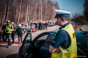 Zdjęcie przedstawiające policjanta ruchu drogowego w trakcie zabezpieczenia.