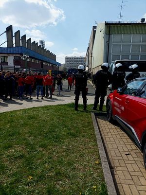 Zdjęcie przedstawiające policjantów oraz kibiców.