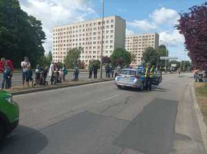 Zdjęcie przedstawiające radiowóz policyjny oraz policjanta ruchu drogowego.