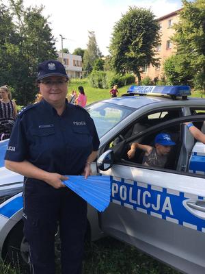 Zdjęcie przedstawiające policjanta oraz uczestników festynu.