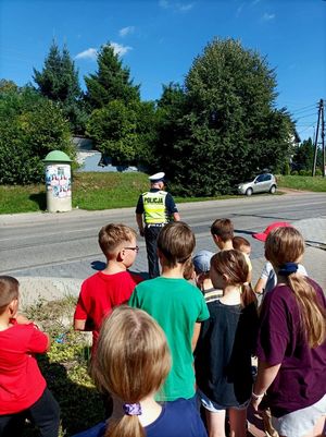 Zdjęcie przedstawiające policjanta oraz uczniów.