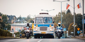 Zdjęcie przedstawiające policjantów na motocyklach oraz autobus.