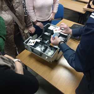 Zdjęcie przedstawiające walizkę profilaktyczną z atrapami narkotyków.