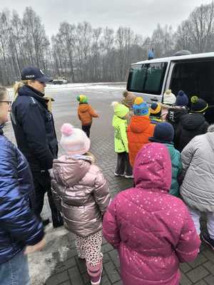 Zdjęcie przedstawiające Policjantkę oraz dzieci przy radiowozie.